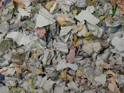 The blades of a commercial paper shredder need to be oiled often to keep them sharp and running efficiently.