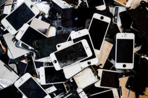 A pile of broken and outdated cell phones ready for cell phone recycling.