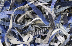 Shredded materials like this pile of shredded denim are easier to dispose of or recycle.