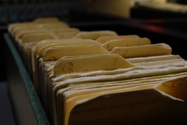 Close-up of aged file folders in a storage drawer, representing outdated records ready for year-end document shredding.