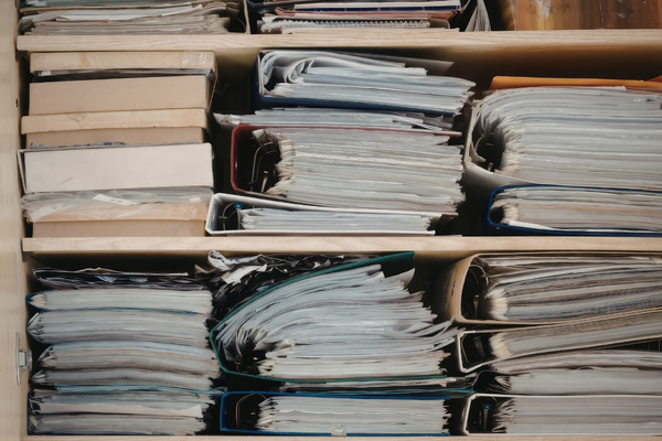 municipal records destruction and records management with archived government paper files stored in municipal office shelving